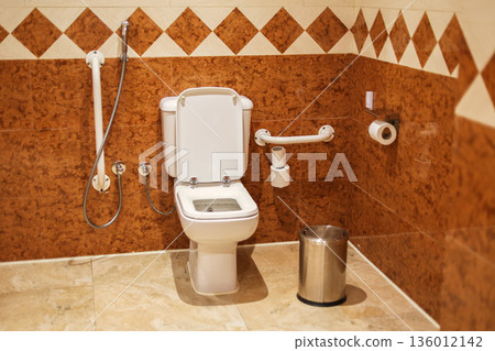 Accessible restroom with grab bars on the wall 136012142