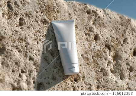 Mockup of a clean white tube on rocky seashore. Ideal presentation for sunblock, soothing face cream, skin care or beauty product packaging design. 136012397