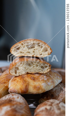 Freshly Baked Artisan Bread Halves Stacked Revealing Airy Interior Freshly Baked Artisan Bread Halves Stacked Revealing Airy Interior 136013598