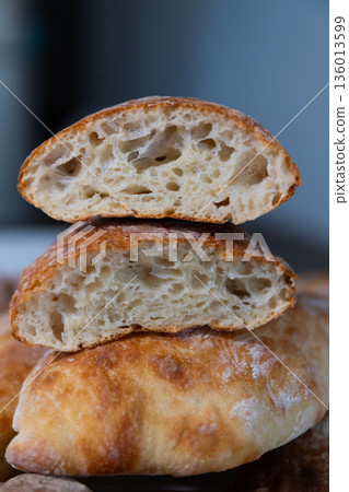Freshly Baked Bread With a Soft Inside and Crispy Crust on Display in a Kitchen Setting Freshly Baked Bread With a Soft Inside and Crispy Crust on Display in a Kitchen Setting 136013599