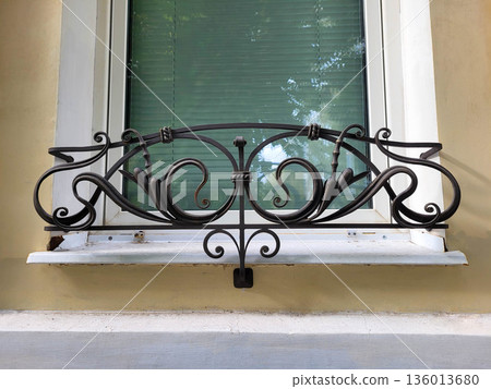 A white window with a black wrought-iron lattice for placing flower pots A white window with a black wrought-iron lattice for placing flower pots 136013680