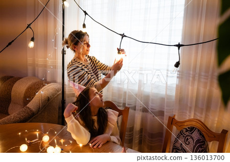 Celebrating a cozy indoor gathering with festive lights and joyful conversation during a mid afternoon celebration 136013700