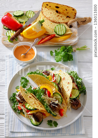 lamb meatball tacos with fresh veggies on a plate 136013800