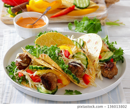 lamb meatball tacos with fresh veggies on a plate lamb meatball tacos with fresh veggies on a plate 136013802