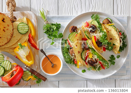 lamb meatball tacos with fresh veggies on a plate 136013804