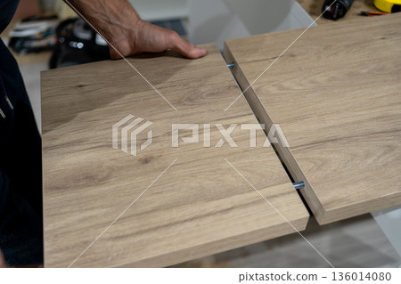 Shop scene involving walnut panel cutting process. Detailed workshop scene showing manual walnut cut with measuring and guiding tools Shop scene involving walnut panel cutting process. Detailed workshop scene showing manual walnut cut with measuring and guiding tools 136014080