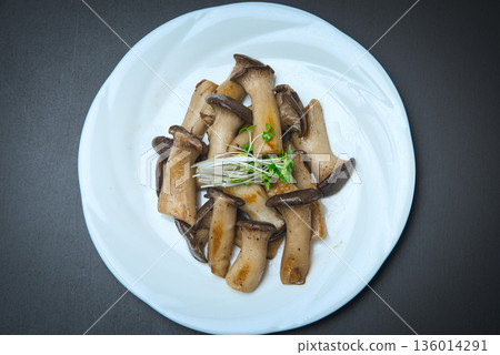 Crunchy king oyster mushrooms stir-fried in butter and served with broccoli sprouts Crunchy king oyster mushrooms stir-fried in butter and served with broccoli sprouts 136014291