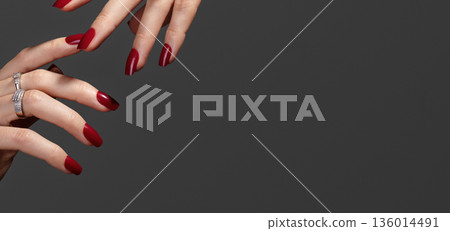 CloseUp Hands With Manicure Showcase Crimson Nails, Stacked Rings, Red Manicured Nails with Gel Polish, Editorial Composition, Nail Art Polished, Luxury Accessory Advertising, Beauty Studio 136014491