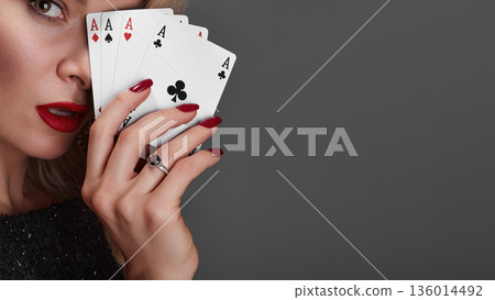 Four Aces Held By Woman Glamorous Closeup Red Lips Red Nails Diamond Ring Sequined Dress Confident Gaze Professional Poker Player Pose High Stakes Poker Vibe Studio Gray Background 136014492