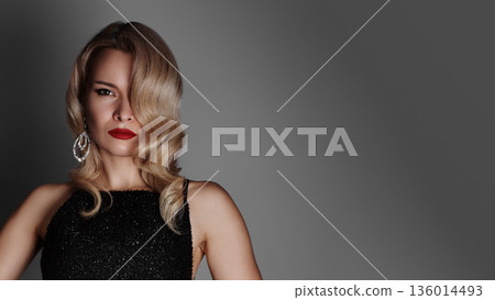 Confident Red Carpet Pose Showing Actress In Sequined Gown, Hands On Hips, Strong Posture, Bold Red Lips, Oversized Chandelier Earrings, Spotlight Glow, Neutral Backdrop, Lifestyle Glamour, Arrival 136014493