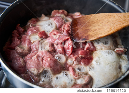 Diced Raw Beef Cooking in Pan Close Up 136014520