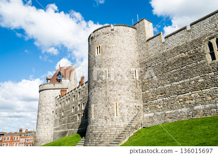 Historic stone Windsor Castle under a bright blue sky and floating clouds, a London suburban streetscape 136015697