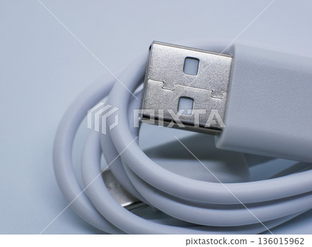 Close-up of white USB cable with connector on clean white background. Charging and data transfer concept for smartphones, gadgets, accessories, technology, mockups and e-commerce Close-up of white USB cable with connector on clean white background. Charging and data transfer concept for smartphones, gadgets, accessories, technology, mockups and e-commerce 136015962