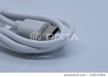Close-up of a white USB-C charging cable isolated on a clean white background. Modern tech accessory for fast charging and data transfer for smartphones, tablets, and laptops Close-up of a white USB-C charging cable isolated on a clean white background. Modern tech accessory for fast charging and data transfer for smartphones, tablets, and laptops 136015964