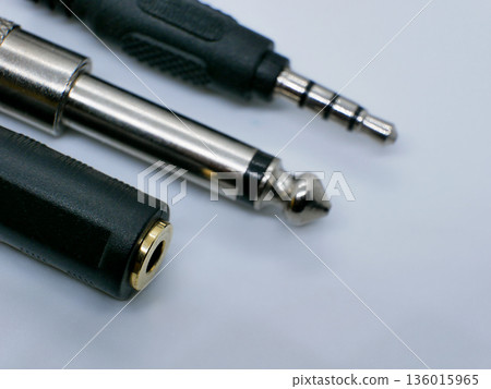 Close-up of audio jack connectors on a clean white background. Professional sound equipment accessories for music, studio recording, headphones, instruments, and audio cables Close-up of audio jack connectors on a clean white background. Professional sound equipment accessories for music, studio recording, headphones, instruments, and audio cables 136015965