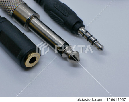 Close-up of audio jack connectors on a clean white background. Professional sound equipment accessories for music, studio recording, headphones, instruments, and audio cables Close-up of audio jack connectors on a clean white background. Professional sound equipment accessories for music, studio recording, headphones, instruments, and audio cables 136015967
