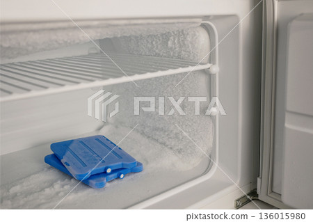 Icy Freezer Shelf with Ice Packs and Frost Buildup 136015980