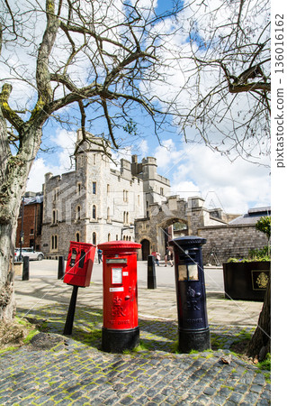 Historic red and navy blue iron postbox in Windsor, a suburb of London 136016162