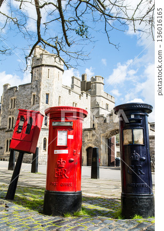 Historic red and navy blue iron postbox in Windsor, a suburb of London 136016165