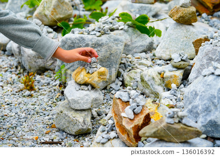 Relaxed spiritually child's hand arrangement pebble tower. Yoga relax meditation Relaxed spiritually child's hand arrangement pebble tower. Yoga relax meditation 136016392
