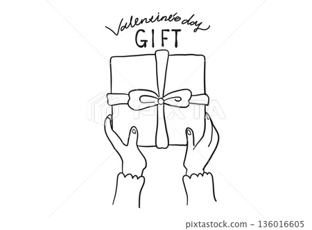 Woman's hand giving a Valentine's Day gift 136016605