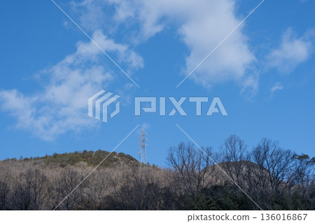 Power line tower built on top of a mountain Power line tower built on top of a mountain 136016867