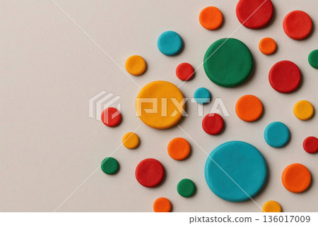 Multi-colored round figures made of plasticine on a light background. Space for text. Multi-colored round figures made of plasticine on a light background. Space for text. 136017009