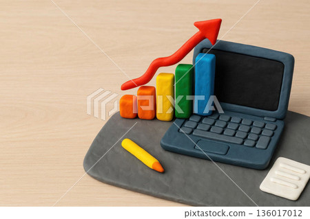 Plasticine laptop with a growing chart and an up arrow. Space for text. 136017012