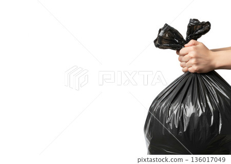 Holding a tied garbage bag with your hand. Space for text. Holding a tied garbage bag with your hand. Space for text. 136017049