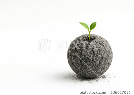 An earthen ball with a sprout on a white background. Space for text. 136017055