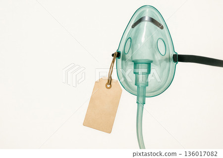 Oxygen mask with a price tag, commercialization of life. Space for text. Oxygen mask with a price tag, commercialization of life. Space for text. 136017082