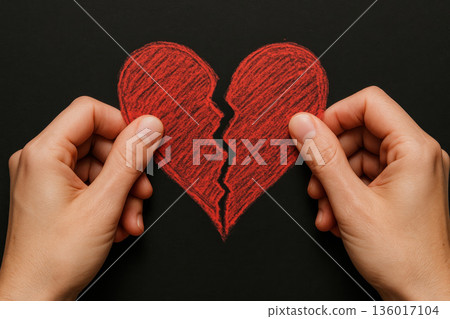 Hands tearing a red paper heart. Hands tearing a red paper heart. 136017104