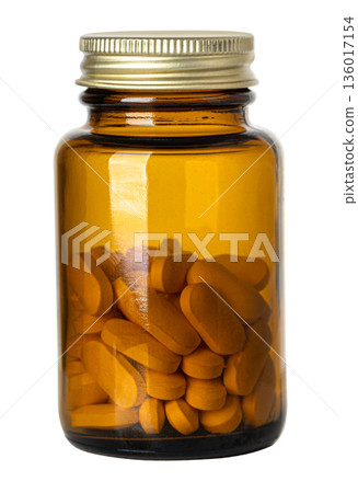 Amber glass medicine bottle filled with pills 136017154
