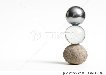 A balancing composition of stone, glass and metal balls. Space for text. A balancing composition of stone, glass and metal balls. Space for text. 136017182