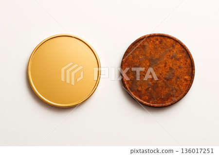 Two coins, one gold and one rusty. Space for text. 136017251