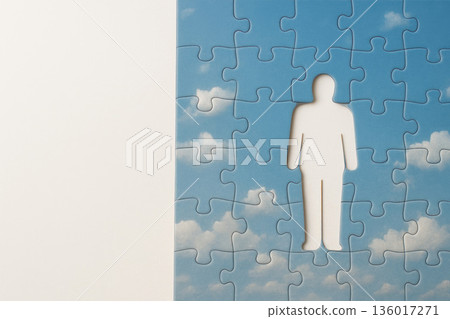 Blue sky with clouds in puzzles and a carved silhouette of a person. Space for text. 136017271