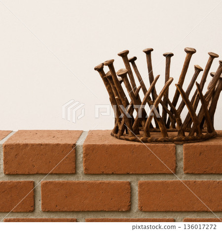 Vintage crown of rusty nails on a brick wall. Space for text. Vintage crown of rusty nails on a brick wall. Space for text. 136017272