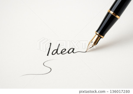 The pen writes the word Idea on the paper. Space for text. The pen writes the word Idea on the paper. Space for text. 136017280