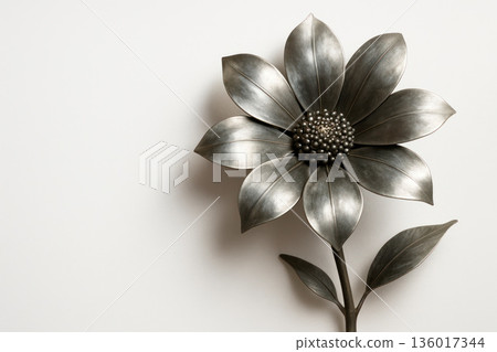 Metallic flower with leaves on a light background Space for text. 136017344