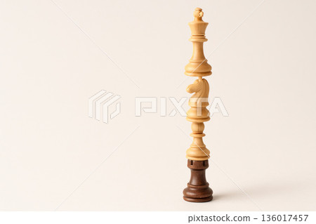 Chess pieces gathered in one vertical tower. 136017457