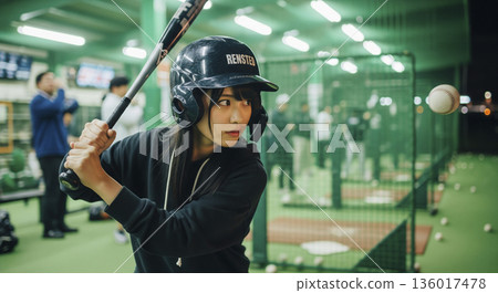 Japanese women enjoying baseball at a batting center 136017478