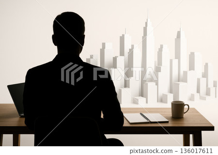 Silhouette of a man looking at a white city model. 136017611