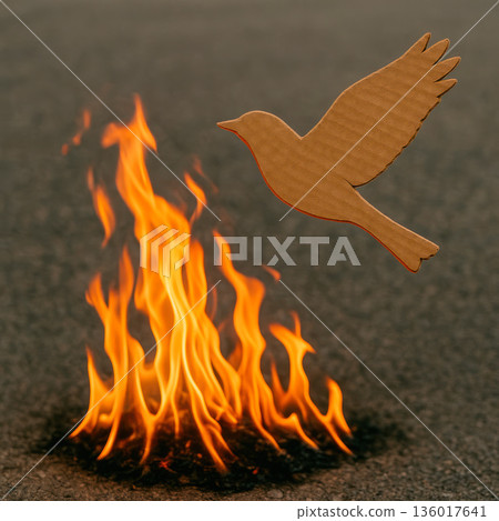 A cardboard bird soars above the fiery flames. Space for text. A cardboard bird soars above the fiery flames. Space for text. 136017641