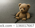 A teddy bear stuck in a hole in the road. Space for text. 136017667