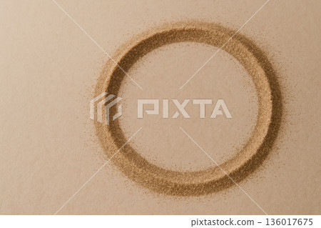 A circle of sand on a beige background. Space for text. A circle of sand on a beige background. Space for text. 136017675