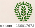 A wreath of green leaves on a light background. Space for text. 136017678