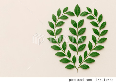 A wreath of green leaves on a light background. Space for text. 136017678