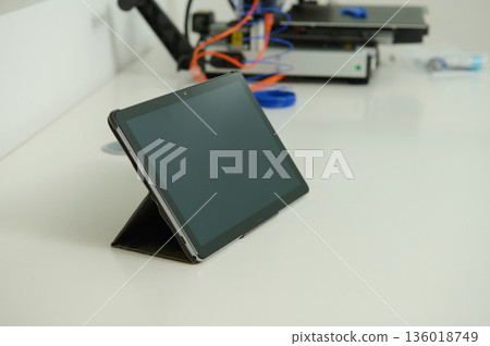 Tablet On Stand At Desk In Modern Office With Cables And Equipment 136018749