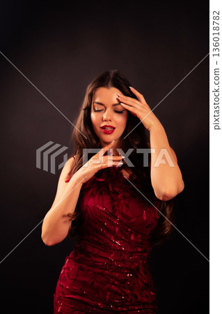 Beautiful woman expresses love for Valentines Day in dark setting with subtle gestures and graceful movements 136018782