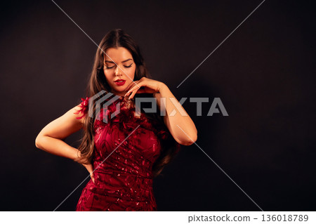 Beautiful woman dressed in red with a thoughtful expression during a love-themed celebration for Valentines Day 136018789